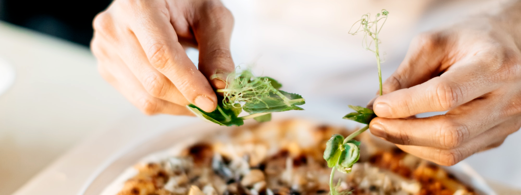 Slide Image of Herbs Being Spread on Pizza